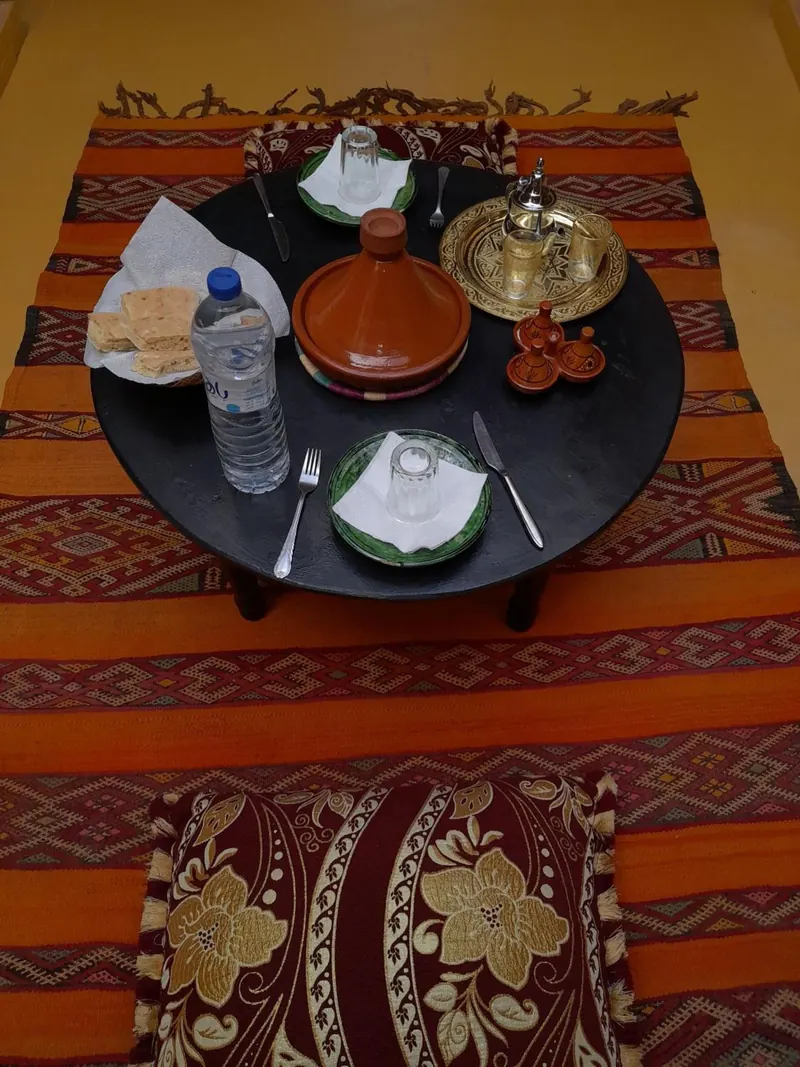 A tagine, bread and mint tea on a low table