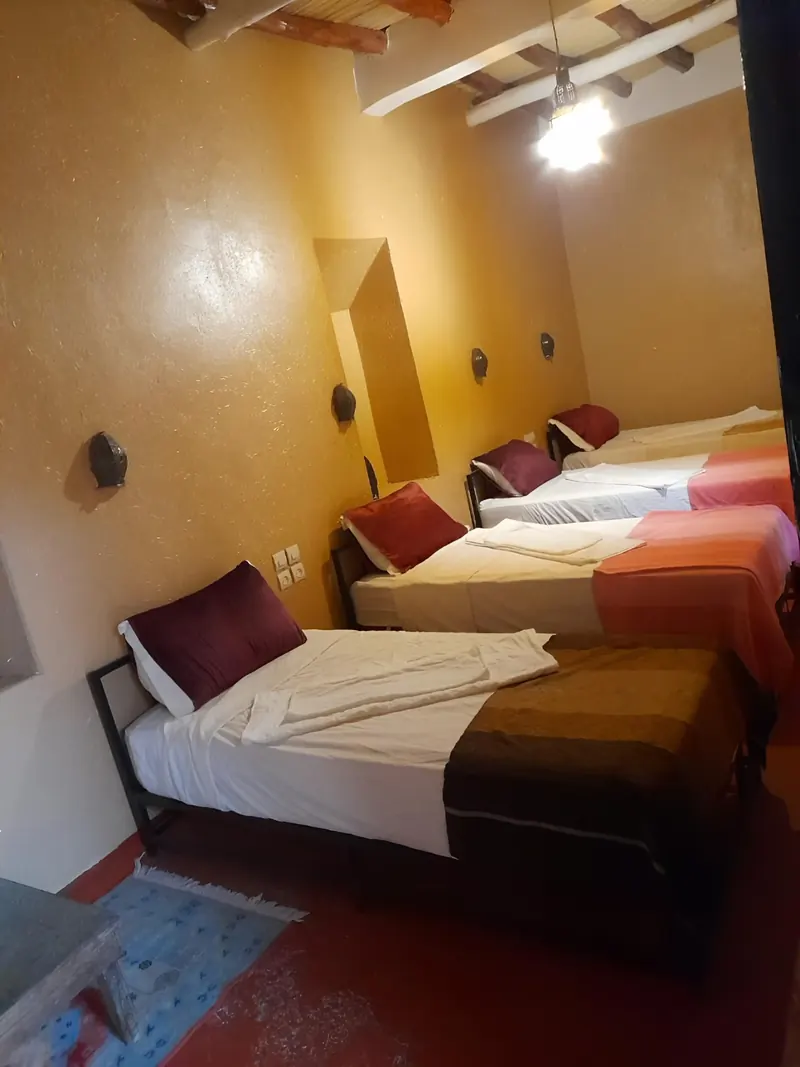Quadruple Room: the four single beds seen from the door