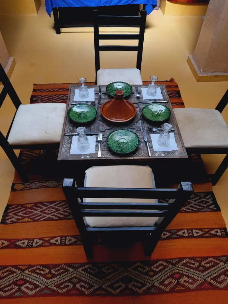 A table set with green plates and a tagine